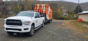 Dodge 3500 hauling  barriers for contaiment on goosneck trailer