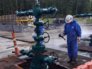 Travis scrubing well heads in the oil and gas industry
